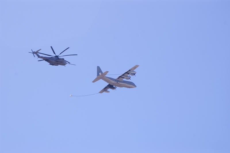  A navy Sikorsky CH-53E Super Stallion being refueled in flight by a Herculees HC-130
