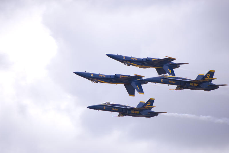navy blue angels performing an upside down airshow display