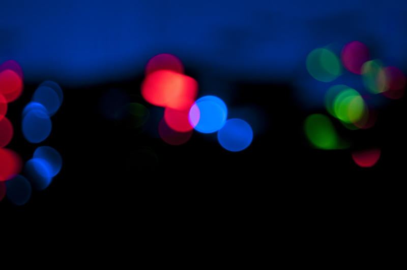 a backdrop of green, red and blue lights