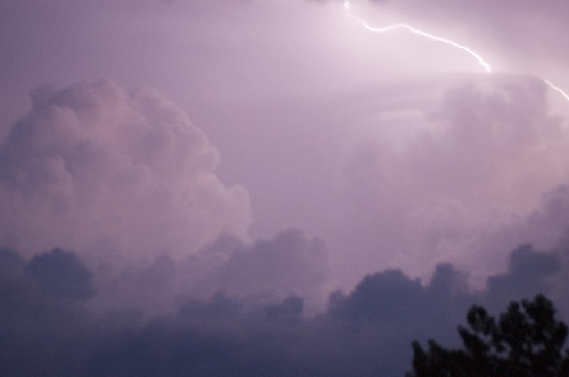 lighting flashes across clouds during a thunderstorm - blurred image