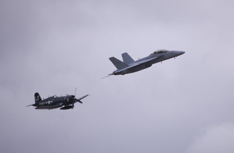 a navy F4U Corsair and an FA18 Hornet in flight