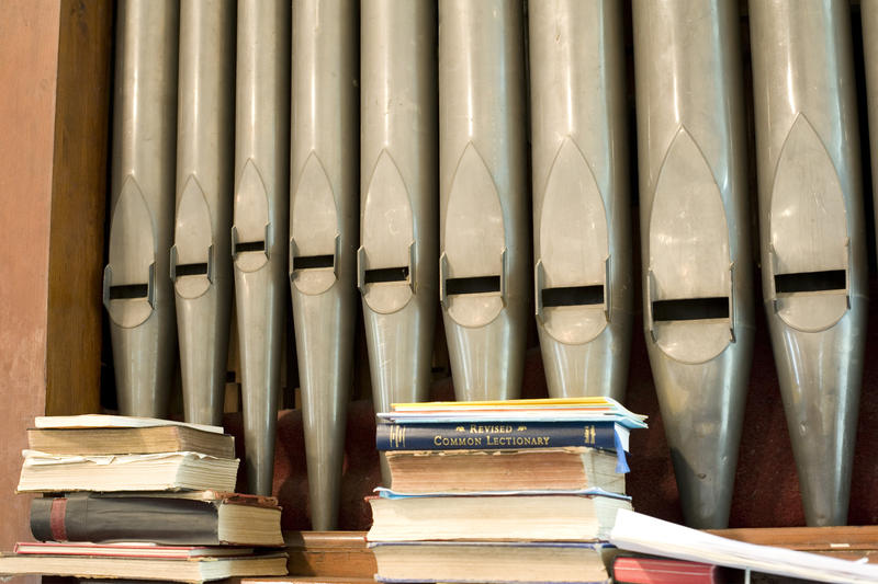 a row of organ pipes on a small church organ