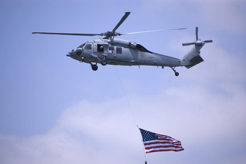 a helicopter dragging the stars and striped