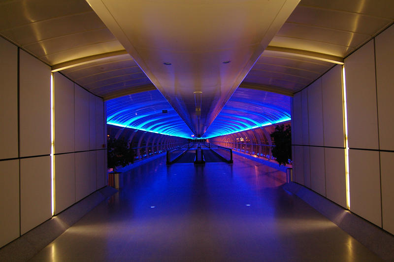 blue neon bridge walkway at manchester airport uk