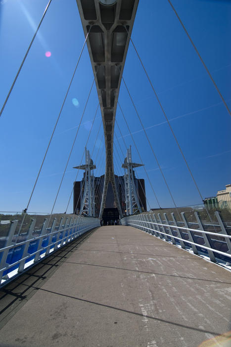 a view taken walking across the pedestrian lift bridge at salford quays, manchester, uk