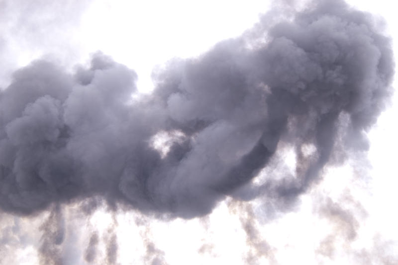 a large cloud of smoke rises into the sky