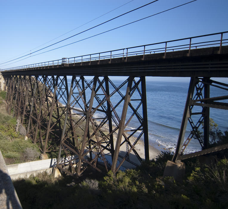 a steel trestle railway bridge on the california coast