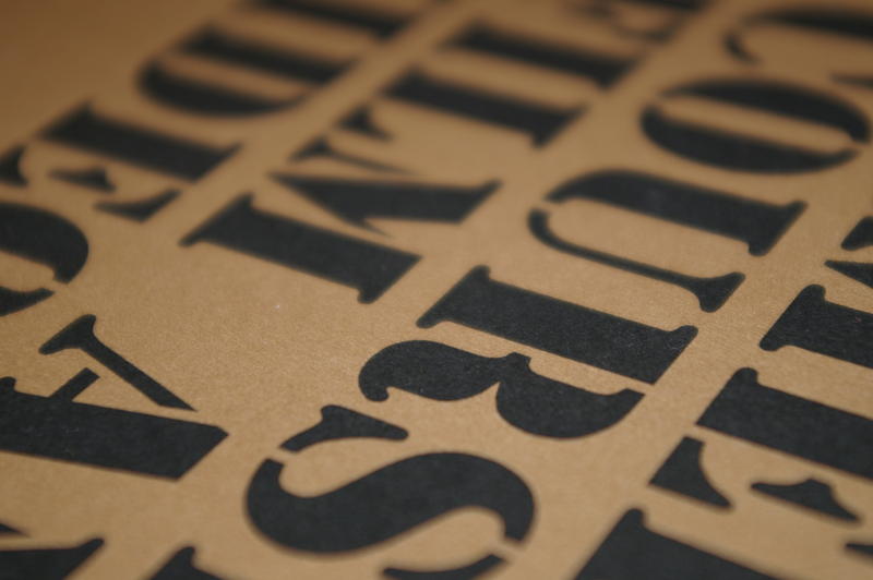 stencil style type on unbleached paper