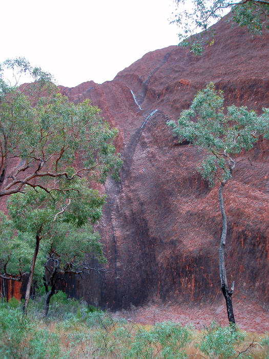 the rare sight of water running down the side of uluru after a passing downpour