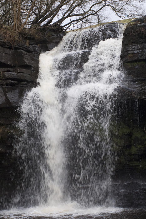 water cascading over a rocky overhang in england