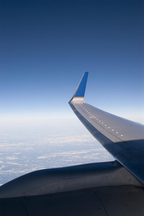 the wing tips viewed from an airliner window