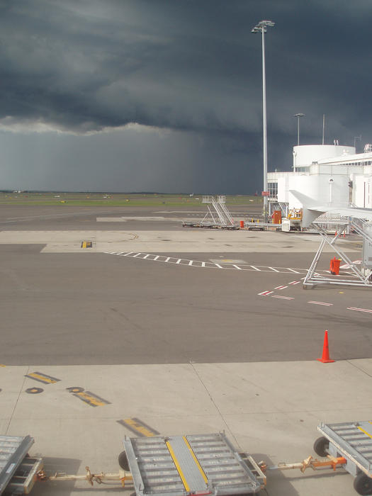 dark rain filled clouds threaten flights from an airport