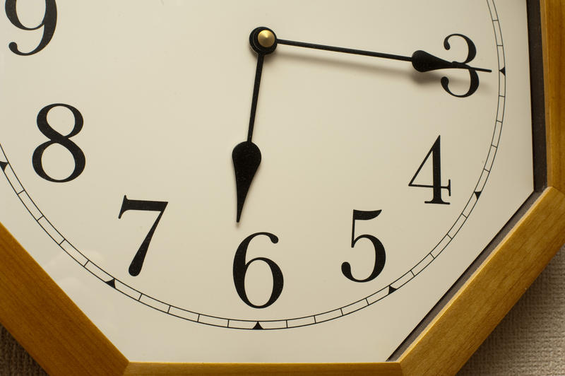 an analog clock face with hands set to 6:15