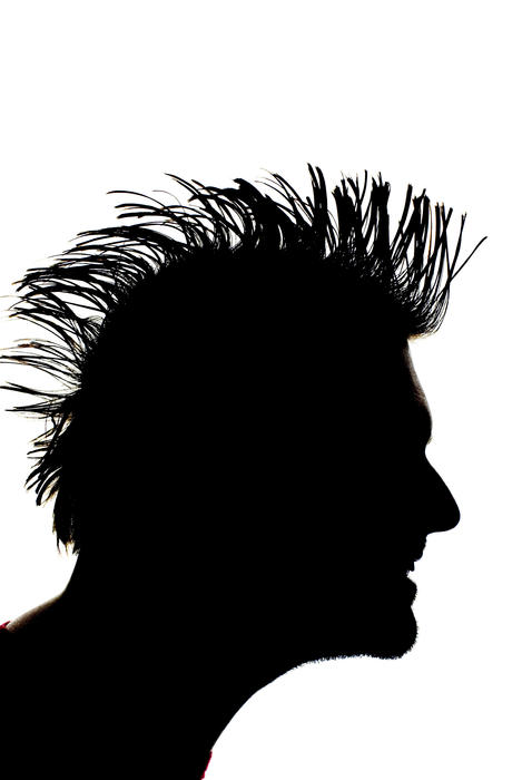 backlit image of a man with mohawk hair