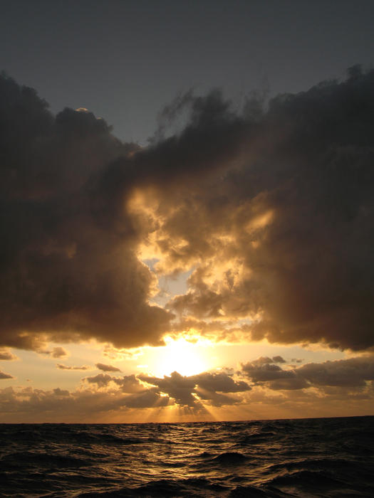 sunbeams shining from behind a storm cloud