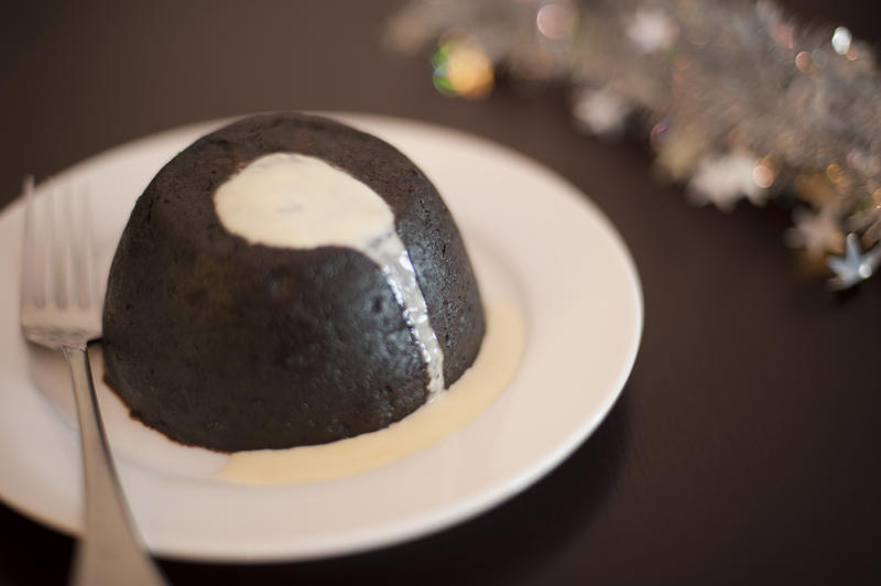 christmas plumb pudding dessert served with brandy custard