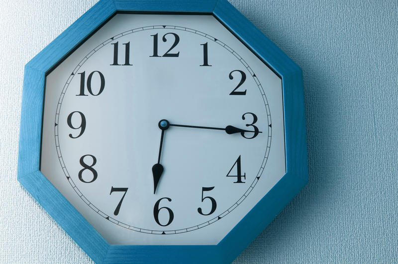 a blue coloured analog clock
