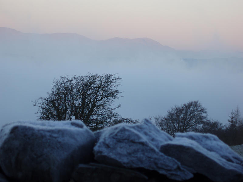 looking across the top of a valley full of cold misty air