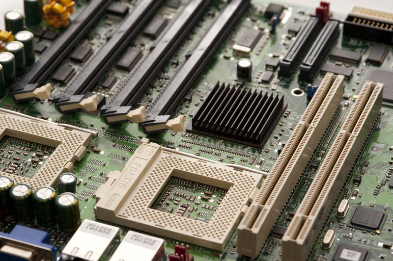 a computer motherboard with CPU sockets, memory slots, PCI card slots and a SCSI interface connections