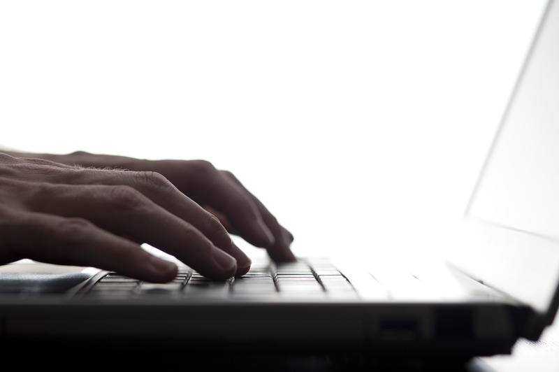 closeup on fingers typing on a keyboard concept of repetitive strain injury or 