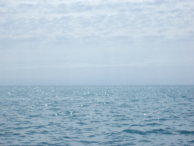 looking ot over the ocean to a distant horizon pictured with an ethereal defocused effect