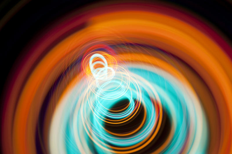 orange and cyan coloured spiraling light beams