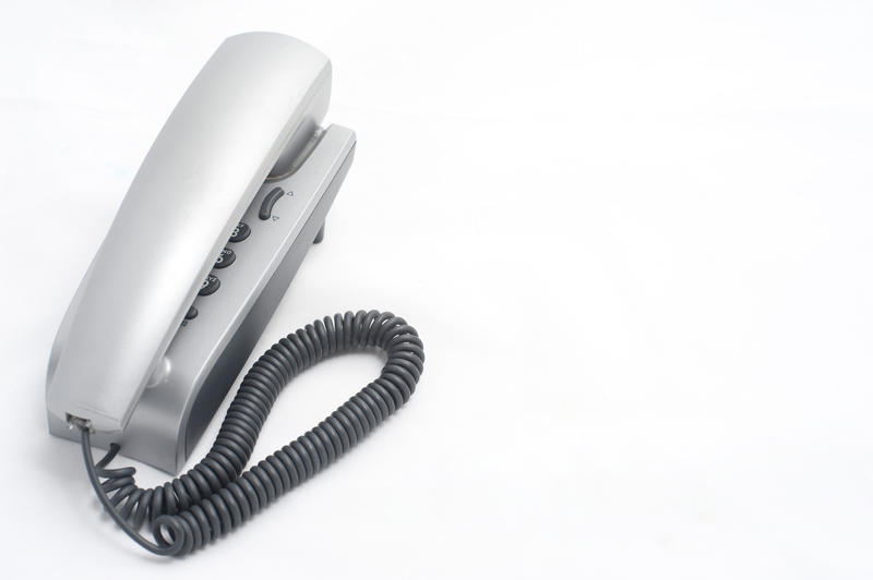 an office phone cutout on a white background with space for text