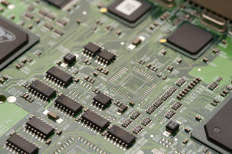 a computer circuit board with surface mount integrated circuits, capacitors and resitors