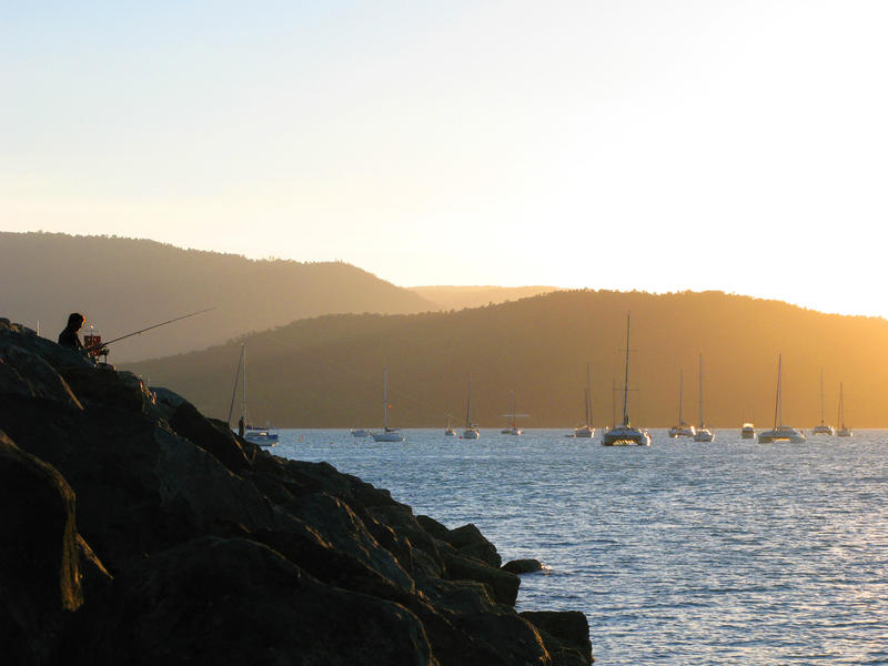 fishing off the rock wall of a marina