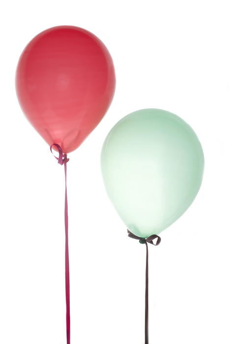 two floating ballons tied down with ribbons