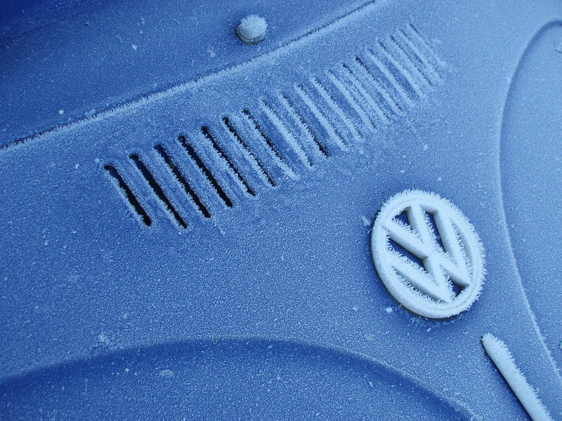 a classic car covered in frost on a cold winter morning