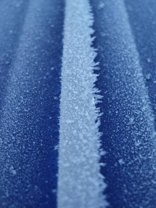 macro image of a car covered in winter frost