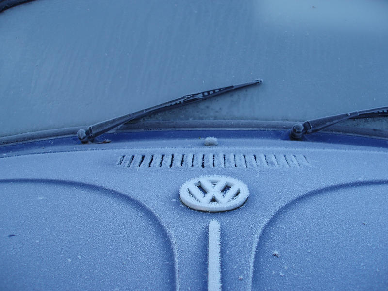 a volkswagen beetle covered in rime frost on a cold winter