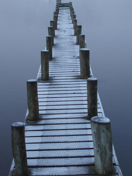 a jetty at fell foot on lake windermere, covered in frost on a cold winter morning