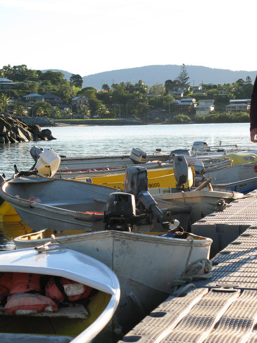 a jetty surrounded by tied up tenders