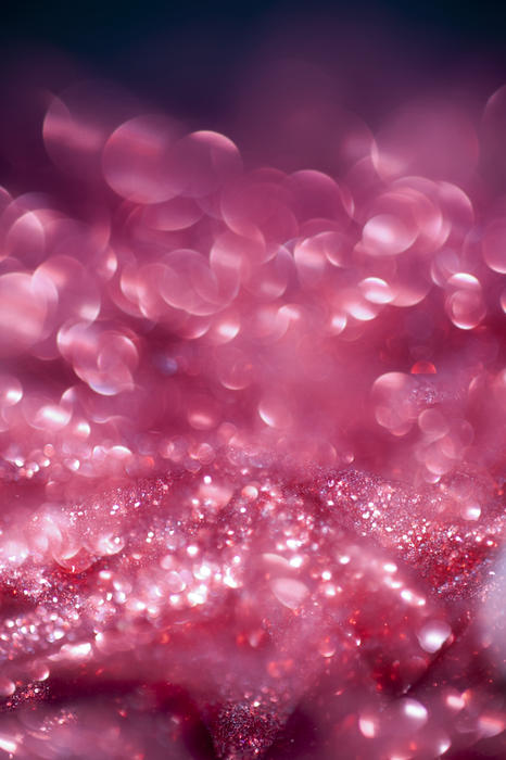 an ethereal looking pink glitter christmas background with bokeh highlights