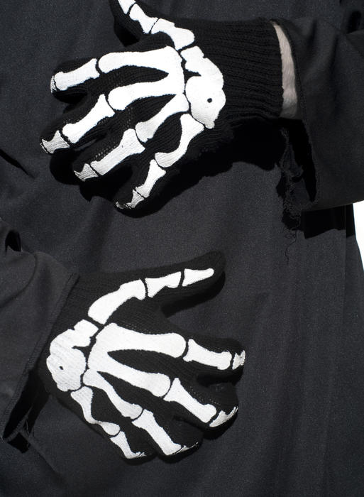 a pair of halloween costume hands, skeleton print gloves