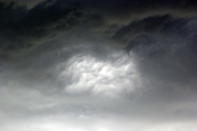 <p>Bright spot in storm clouds</p>Hole inside storm clouds
