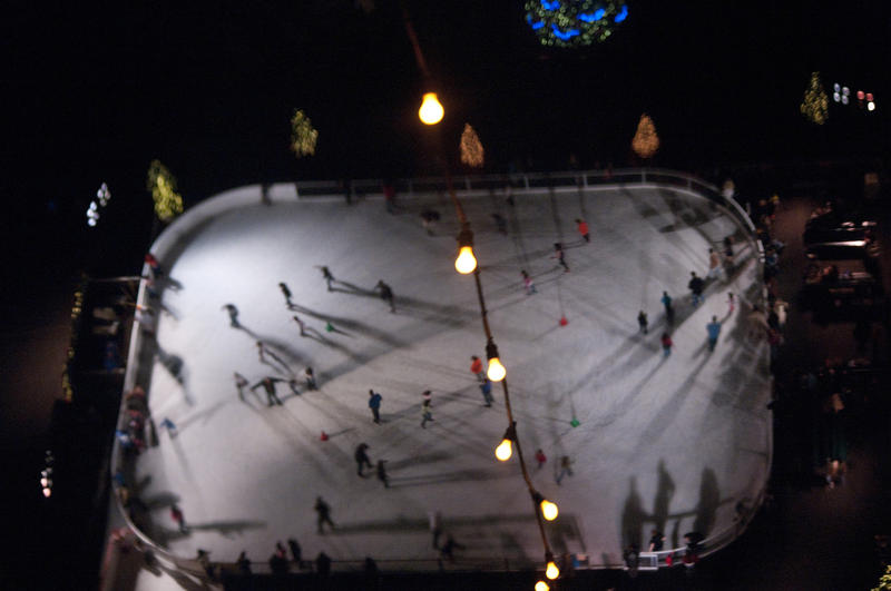 looking down on at skaters on a christmas ice rink