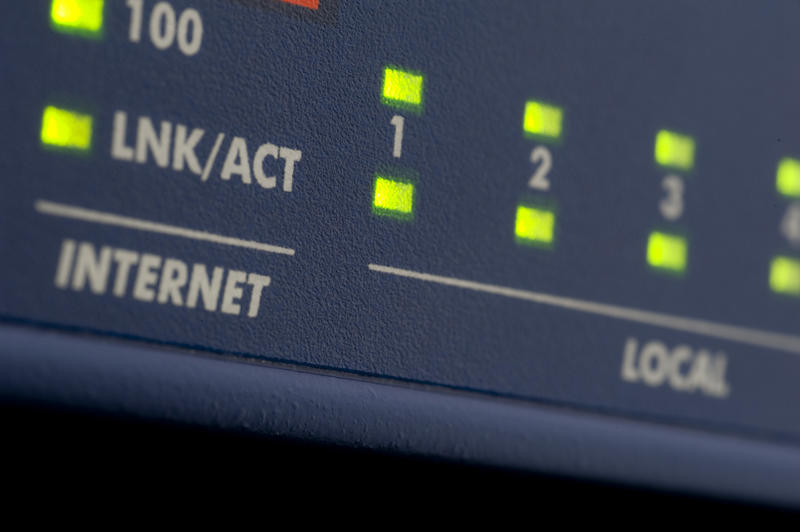 green data lights on the front of an internet network router