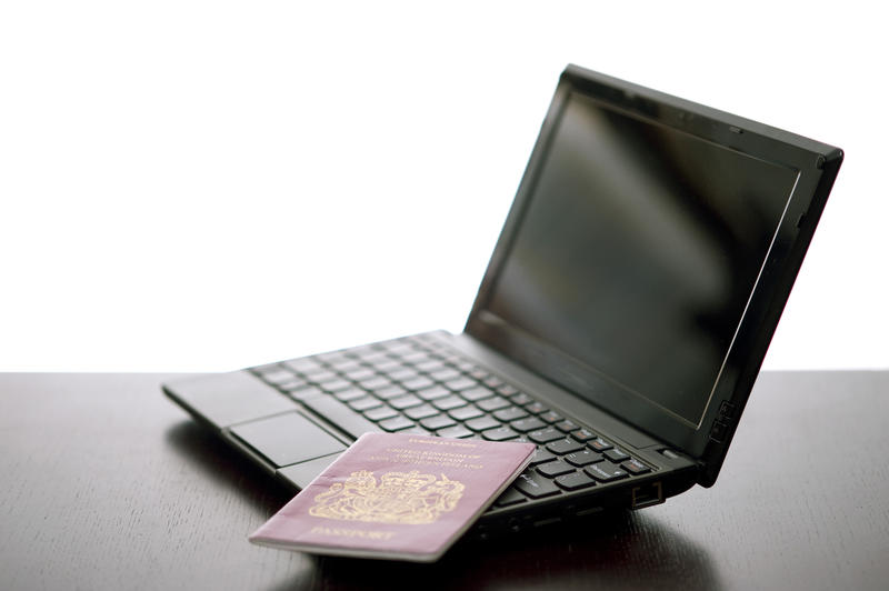 travel concepts, a laptop computer and a passport, online travel booking