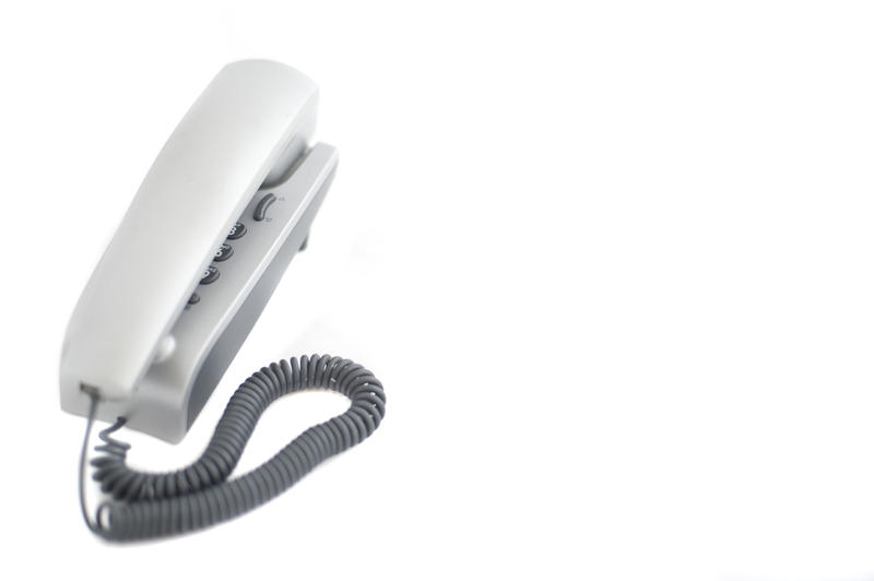 a modern desk telephone cutout on a white background