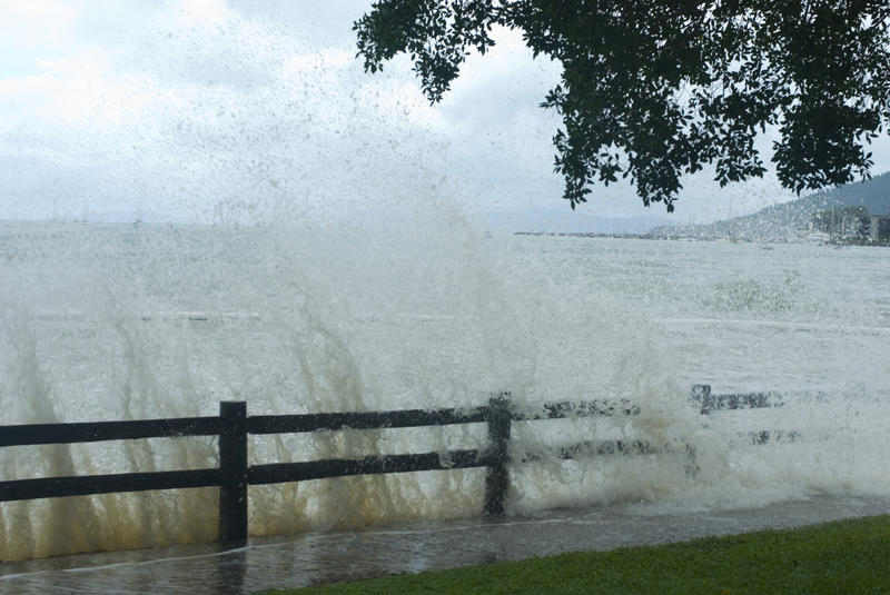 waves surging over a sea wall at a spring tide