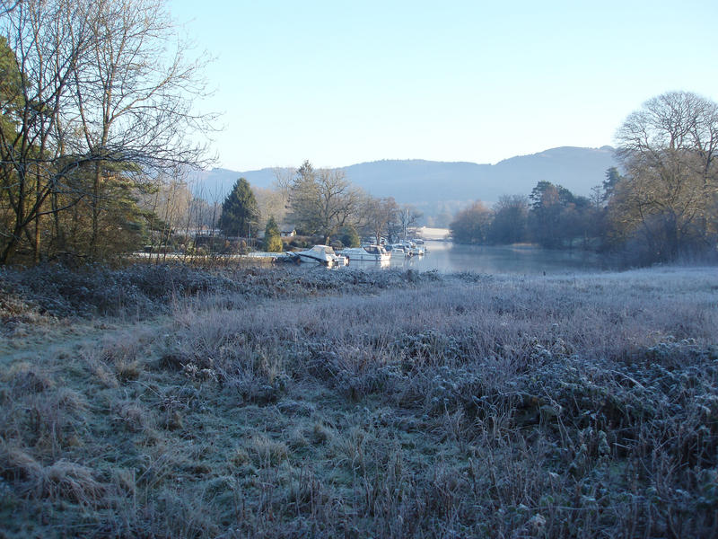 a meadow at the side of lake windermere near the hotel marina