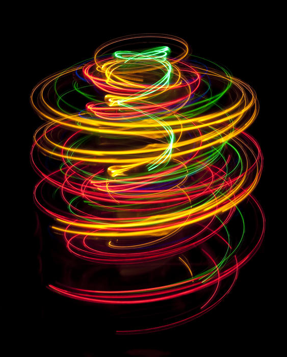 spiral lines of vivid coloured lights on a black background