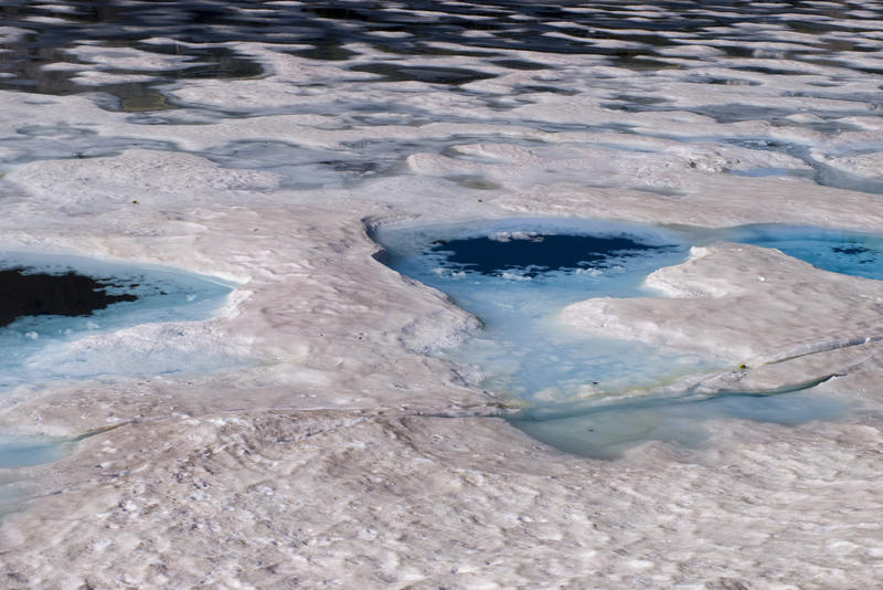 blue mineral rich meltwater on a alpine snowflat