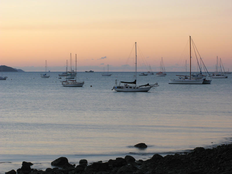 sunset over yachts moored in muddy bay, airlie beach. australia