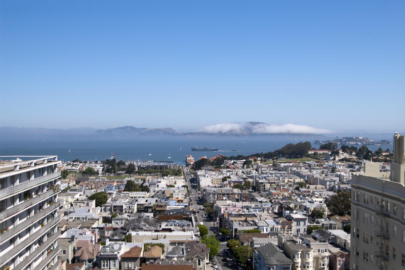 view from a building on top of san francosco nob hill looking out across the bay