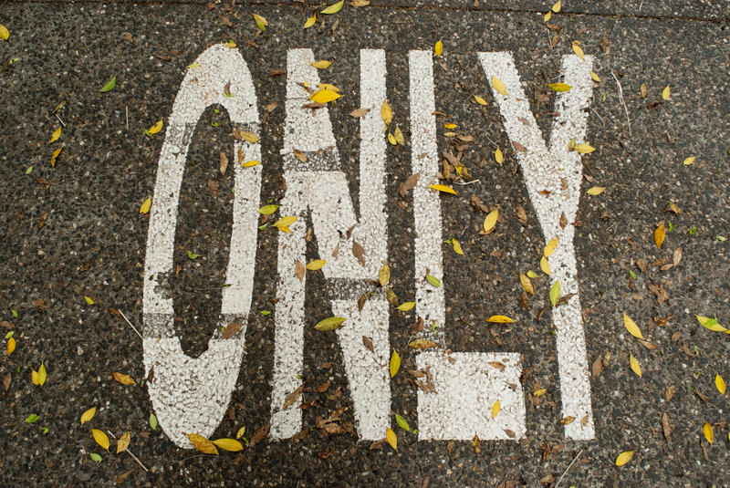 a painted marking on a roadway "only"