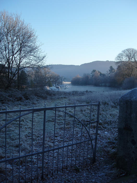 a view looking out over an open gate to lake windermere at newby bridge, cumbria. UK.